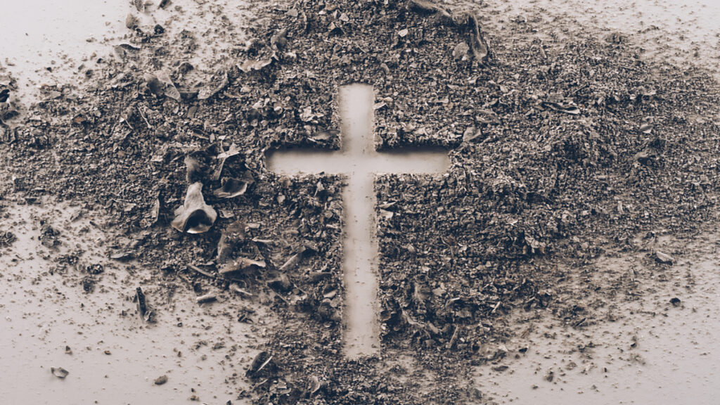 Cross shape made of dirt on dusty ground