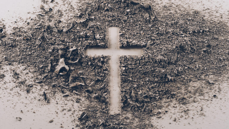 Cross shape made of dirt on dusty ground