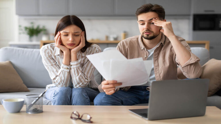 Worried european couple with paperwork and laptop - RDP dev